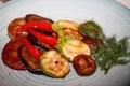 Grilled fresh and organic traditional vegetable. Grilled tomotoes, peppers, mushrooms, eggplant and zucchini on the plate Royalty Free Stock Photo