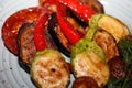 Grilled fresh and organic traditional vegetable. Grilled tomotoes, peppers, mushrooms, eggplant and zucchini on the plate Royalty Free Stock Photo