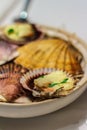 Grilled Fresh Scallop on Shell and lemon on the plate side view Royalty Free Stock Photo