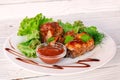 Grilled fried meat on a plate with salad and herbs, shish kebab in tomato sauce Royalty Free Stock Photo