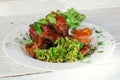 Grilled fried meat on a plate with salad and herbs, shish kebab in tomato sauce Royalty Free Stock Photo