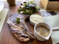 Grilled or fried pork chops on the bone with salad and mashed potatoes served on wooden board Royalty Free Stock Photo