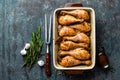 Grilled fried roast chicken legs, drumsticks on dark background, meat with ingredients for cooking Royalty Free Stock Photo