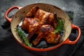 Grilled fried roast Chicken Tabaka in frying pan with rosemary