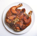 Grilled fried roast Chicken Tabaka on white plate