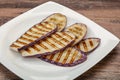 Grilled graffiti eggpant slices with oil Royalty Free Stock Photo