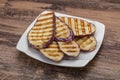Grilled graffiti eggpant slices with oil Royalty Free Stock Photo