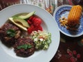 Grilled grassfed organic hamburgers with coldslaw and avocado chef plate