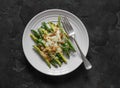 Grilled green string beans with mozzarella and lemon bread crumbs on a dark background, top view Royalty Free Stock Photo