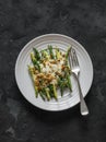 Grilled green string beans with mozzarella and lemon bread crumbs on a dark background, top view Royalty Free Stock Photo