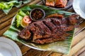 Grilled gurami or grilled gurame with red barbecue sauce, vegetables and chili sauce served on banana leaves