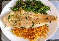 Grilled hake with corn and peas.