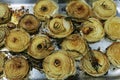 Grilled half white onions with herbs on a metal tray