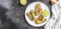 Grilled Halloumi cheese, avocado guacamole, arugula on roasted bread. banner, menu recipe place for text, top view