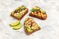 Grilled Halloumi cheese, avocado guacamole, arugula on roasted bread. Food recipe background. Close up