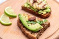 Grilled Halloumi cheese, avocado guacamole, arugula on roasted bread. Food recipe background. Close up