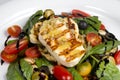 Grilled Halloumi Cheese poured with garlic olive oil salad witch grilled eggplant, cherry tomatoes, black olives and spinach Royalty Free Stock Photo