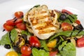 Grilled Halloumi Cheese poured with garlic olive oil salad witch grilled eggplant, cherry tomatoes, black olives and spinach Royalty Free Stock Photo