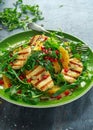 Grilled Halloumi Cheese salad with orange, rocket leaves, pomegranate and pumpkin seed. healthy food Royalty Free Stock Photo