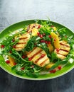 Grilled Halloumi Cheese salad with orange, rocket leaves, pomegranate and pumpkin seed. healthy food Royalty Free Stock Photo