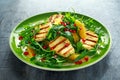 Grilled Halloumi Cheese salad with orange, rocket leaves, pomegranate and pumpkin seed. healthy food Royalty Free Stock Photo