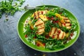 Grilled Halloumi Cheese salad with orange, rocket leaves, pomegranate and pumpkin seed. healthy food Royalty Free Stock Photo