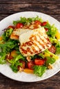 Grilled Halloumi Cheese salad witch orange, tomatoes and lettuce. healthy food