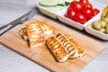 Grilled haloumi cheese on a wooden board with olives, cherry, cucumbers and pepperoni Royalty Free Stock Photo