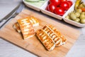 Grilled haloumi cheese on a wooden board with olives, cherry, cucumbers and pepperoni Royalty Free Stock Photo