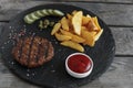 Grilled hamburger with potatoes and pickled cucumber sauce