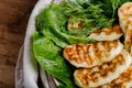Grilled homemade halumi cheese with fresh green herbs