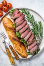 Grilled Homemade rib eye Steak sandwich with sliced roast beef, arugula. White background. Top view Royalty Free Stock Photo