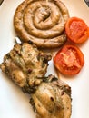 grilled homemade sausage and pieces of barbecue chicken on the table Royalty Free Stock Photo