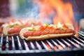 grilled hot dogs on bbq with flames in background Royalty Free Stock Photo