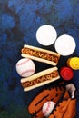 Grilled hot dogs with mustard and ketchup on the table with draft beer. Baseball party food with balls for the playoffs