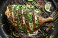 Grilled John Dory fish with lime and parsley in a pan. Gray background. Top view Royalty Free Stock Photo