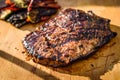 Grilled juicy marinated angus beef flank steak on wooden board Royalty Free Stock Photo