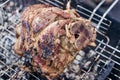 Grilled juicy pork knuckle. Appetizing knuckle or boar hoof. Cooking pork leg on coals. Close-up. Selective focus Royalty Free Stock Photo