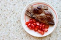 Grilled juicy pork meat steak with vegetables cherry tomatoes on a white plate Royalty Free Stock Photo