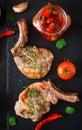 Grilled juicy steak on the bone with vegetables on a dark background. Royalty Free Stock Photo