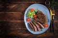 Grilled juicy steak medium rare beef with spices and fresh salad. Royalty Free Stock Photo