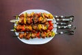 Grilled kebab cooking on metal skewer closeup. Roasted meat cooked at barbecue. BBQ fresh beef meat chop slices. Royalty Free Stock Photo