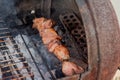 Grilled kebab cooking on metal skewer closeup. Roasted meat cooked at barbecue. BBQ fresh beef meat chop slices Royalty Free Stock Photo