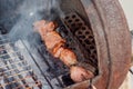 Grilled kebab cooking on metal skewer closeup. Roasted meat cooked at barbecue. BBQ fresh beef meat chop slices Royalty Free Stock Photo