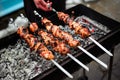 Grilled kebab cooking on metal skewer. Roasted meat cooked at barbecue. Traditional eastern dish, shish kebab. Grill on Royalty Free Stock Photo