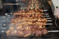 Grilled kebab cooking on metal skewer. Roasted meat cooked at barbecue. BBQ fresh beef meat chop slices Royalty Free Stock Photo