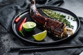 Grilled king klip, congrio with teriyaki sauce. Black background. Top view