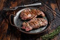 Grilled Lamb chop leg steaks, mutton meat with herbs. Wooden background. Top view Royalty Free Stock Photo