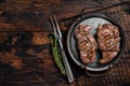 Grilled Lamb chop leg steaks, mutton meat with herbs. Wooden background. Top view. Copy space Royalty Free Stock Photo