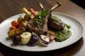 Grilled lamb chops complemented by a refreshing mint pesto, perfectly roasted potatoes, and a medley of seasonal vegetables. Royalty Free Stock Photo